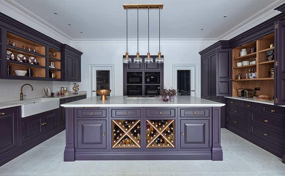 Dark painted Tom Howley kitchen with central island. 