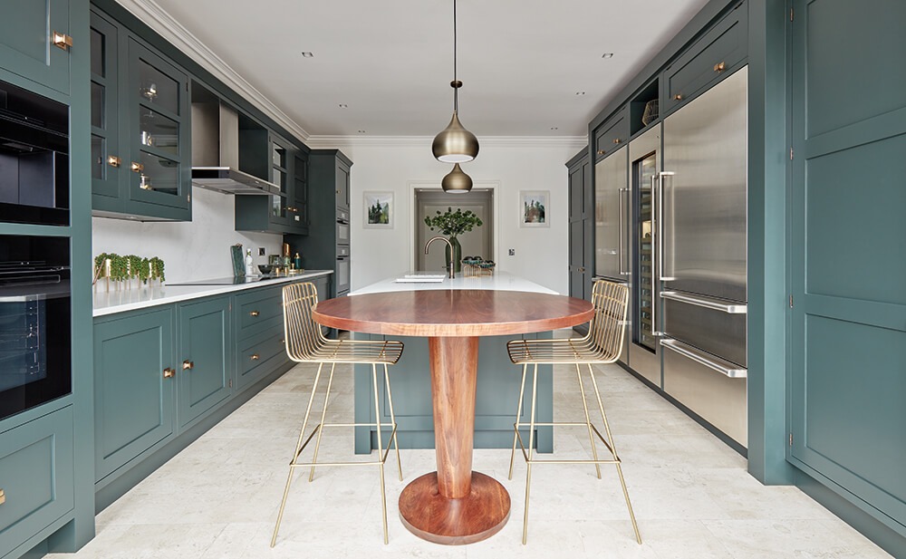 Tom Howley green kitchen with pedestal table island. 