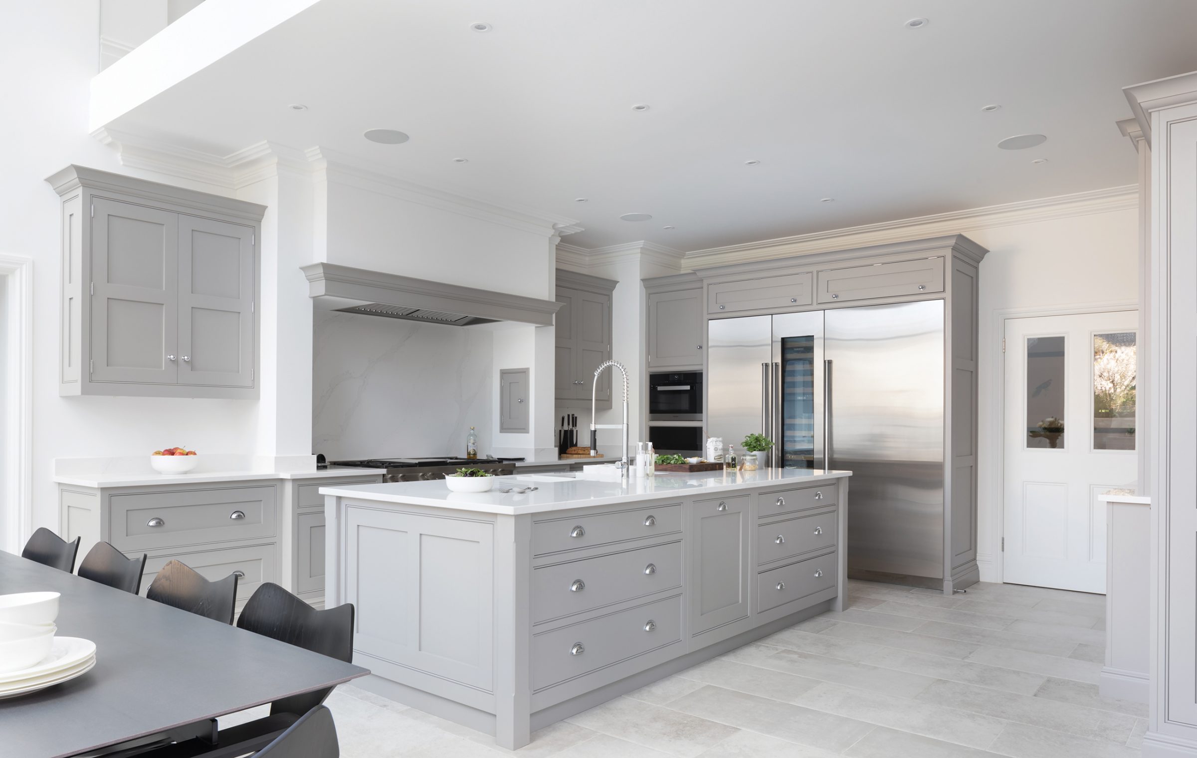 Tom Howley grey fitted kitchen with modern appliances.