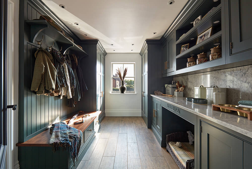 Dark green traditional boot room design. 