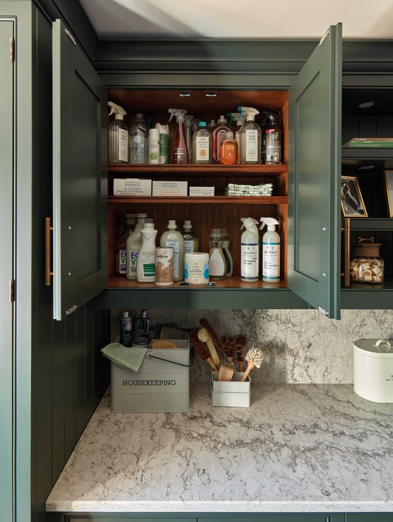 Hidden boot room storage with adjustable walnut shelves. 