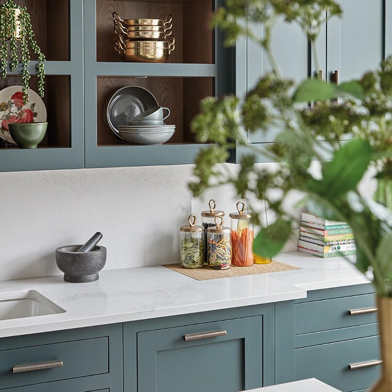 Green shaker kitchen design with open shelving.