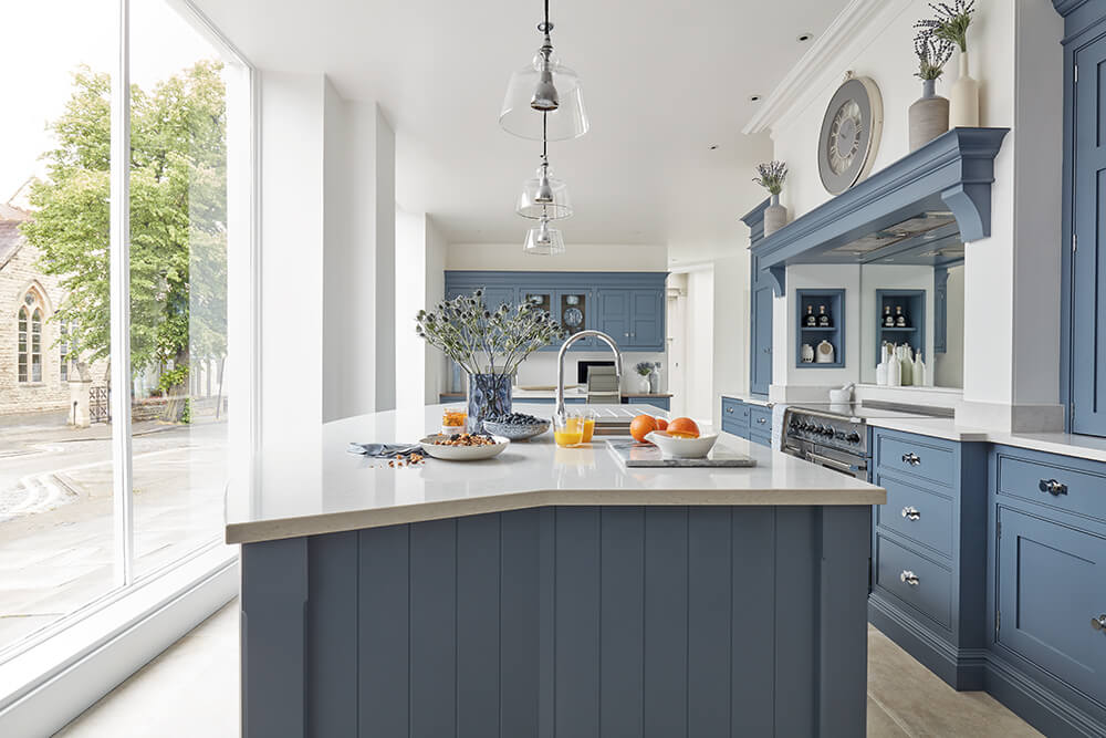 Blue painted Tom Howley kitchen with central island. 