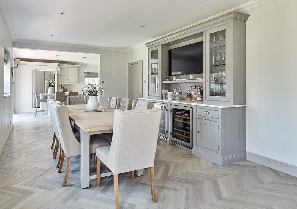 Grey painted dining area with bespoke bar. 