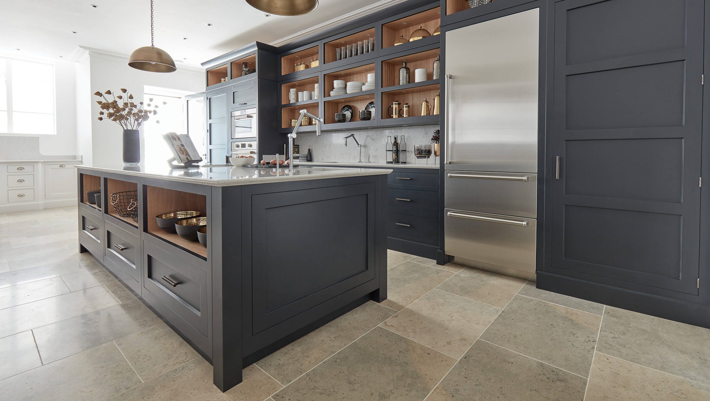 Tom Howley dark Kavanagh design featuring Pure Stone kitchen flooring.