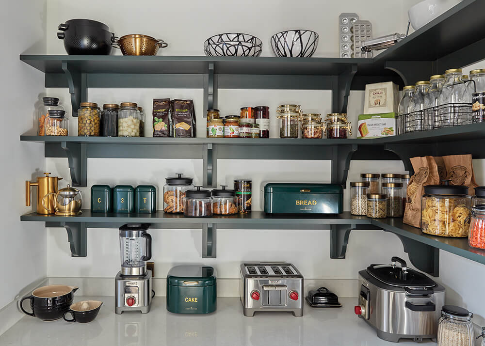 Tom Howley bespoke green pantry with open shelving.