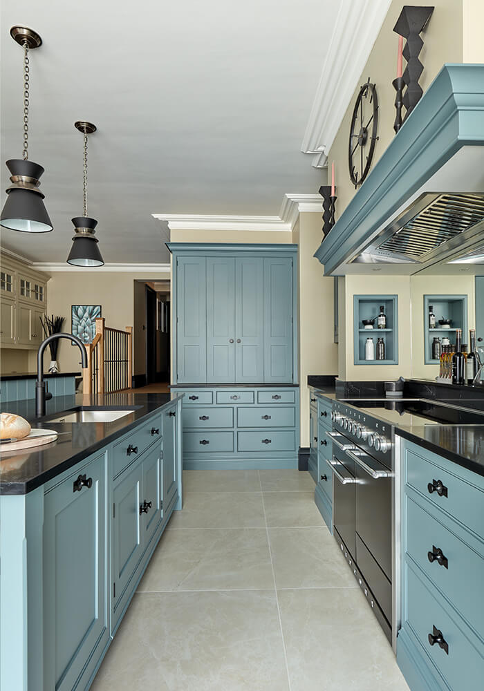 Tom Howley blue kitchen with striking black work surface. 