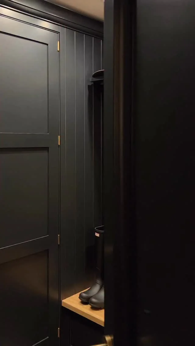 There’s something so comforting about returning home after a crisp morning outdoors.

Jackets, scarves, and muddy boots find their place, and the space just feels ready to welcome you in. The deep, moody Nightshade cabinetry paired with warm, natural textures brings a sense of calm and comfort, creating a room that feels grounded, the perfect pause between the outdoors and home life.

#tomhowley #bootroom #autumnmood #moodyinteriors