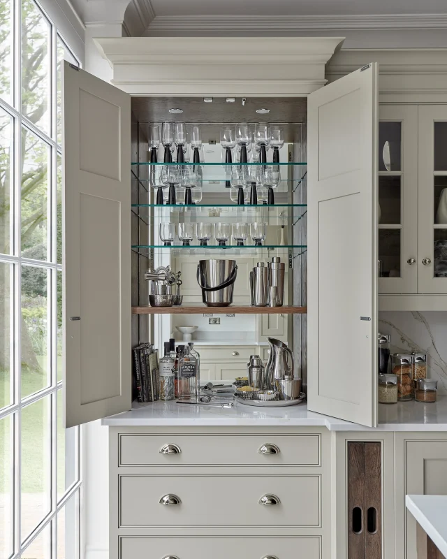 There’s something satisfying about a bar that disappears when you don’t need it. Tucked neatly behind cabinetry, this one feels like a bit of a hidden gem.

What makes it work so well? A mirrored back reflects the space, adding depth and a sense of openness. Glass shelving keeps the look airy while allowing your glassware to take centre stage. And when you’re finished, it all closes away, keeping the kitchen calm and clutter-free.

Tag somebody who would love this in their home?

#tomhowley #homebar #kitchenstorageideas #hiddenstorage #interiordesignideas