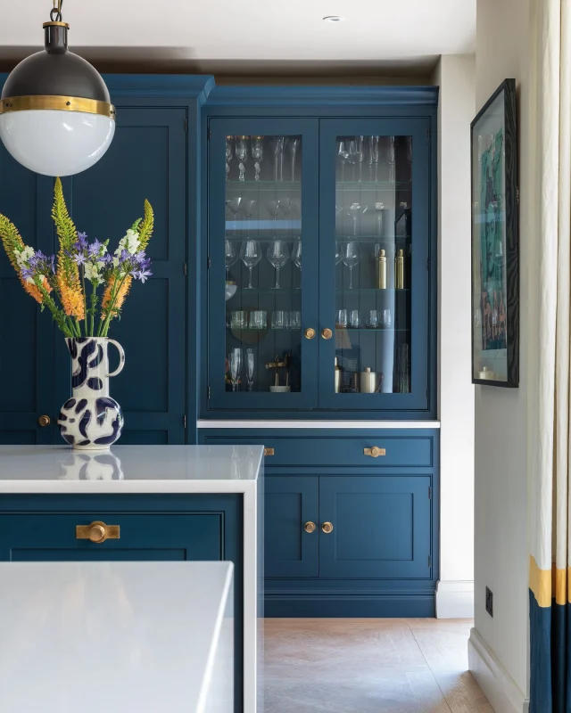 In a multigenerational home, storage isn't just about space; it's about sanity. Floor-to-ceiling cabinetry reclaims every inch without crowding the room.

Glass-fronted cupboards at eye level do something clever too: they turn everyday crockery into a quiet, considered display. This kitchen honours both. Concealed pantry storage for everyday essentials and open glazed displays for the glassware and dishware worth showing off.

As featured in @houseandgardenuk.

Request your free brochure for more inspiration — link in bio.

#tomhowley #bespokekitchen #glazedstorage #storageideas #houseandgarden