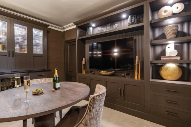 Media walls are increasingly favoured for their ability to declutter and integrate technology into the home.

Spanning the back of this room, the bespoke media wall anchors the space. Finished in Hazelwood, it features tactile reeded back panels, integrated LED lighting, and a mix of open and closed cabinetry — open shelving for sculptural ceramics and glassware, closed storage for everything entertainment-related that doesn't need to be seen.

The seamless TV integration turns it into both a visual focal point and a genuinely functional zone.

Thinking about a media wall for your space? Discover inspiration via the link in our bio.

#tomhowley #mediawall #interiordesign #kitchendesign #livingroominspo